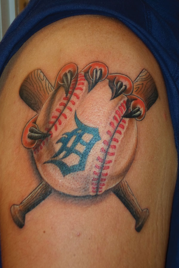 Color shoulder tattoo of a Detroit baseball with red stitching and crossed wooden bats behind it