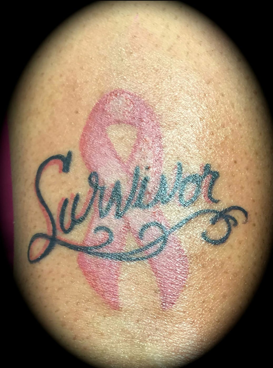Pink awareness ribbon with the word Survivor lettered across it in flowing script