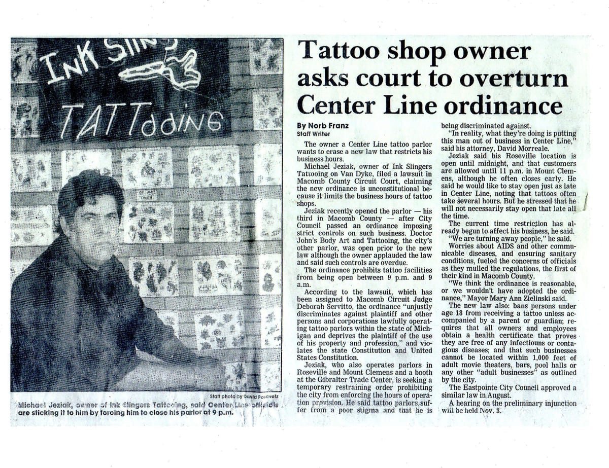 Newspaper clipping headlined Tattoo shop owner asks court to overturn Center Line ordinance, with a photograph of Mike Jeziak in the studio