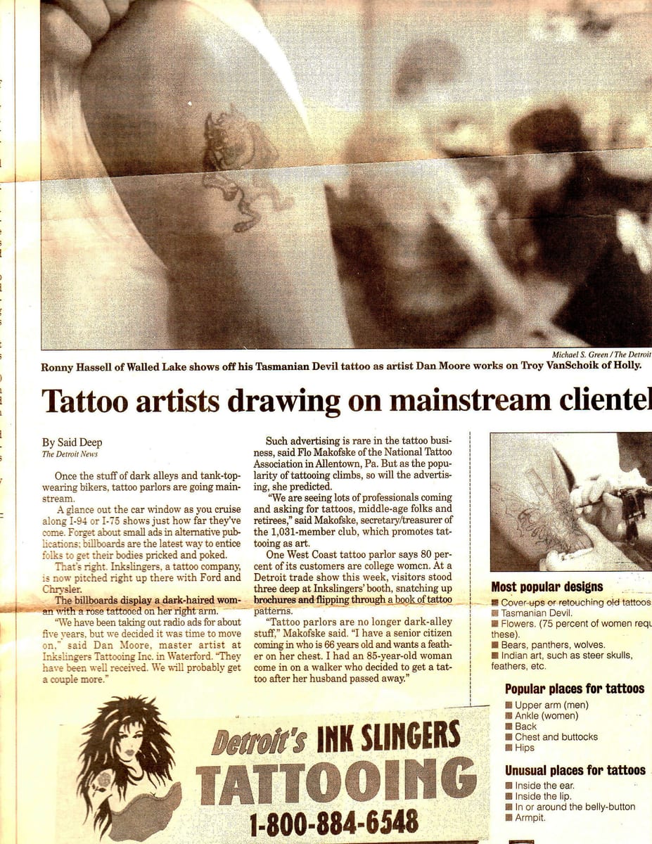 Newspaper feature headlined Tattoo artists drawing on mainstream clientele, with photographs of tattooed arms and an Ink Slingers advertisement